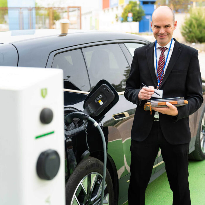 smiling-businessman-using-a-tablet-while-charging-ELWUJ3Q.jpg